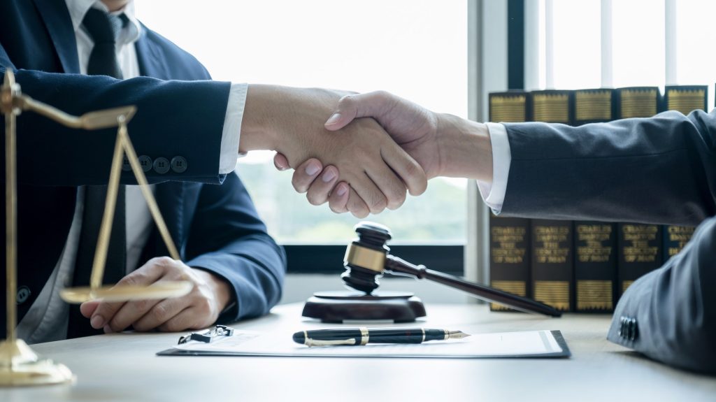Handshake after Lawyer providing legal consult business dispute service to the man at the office
